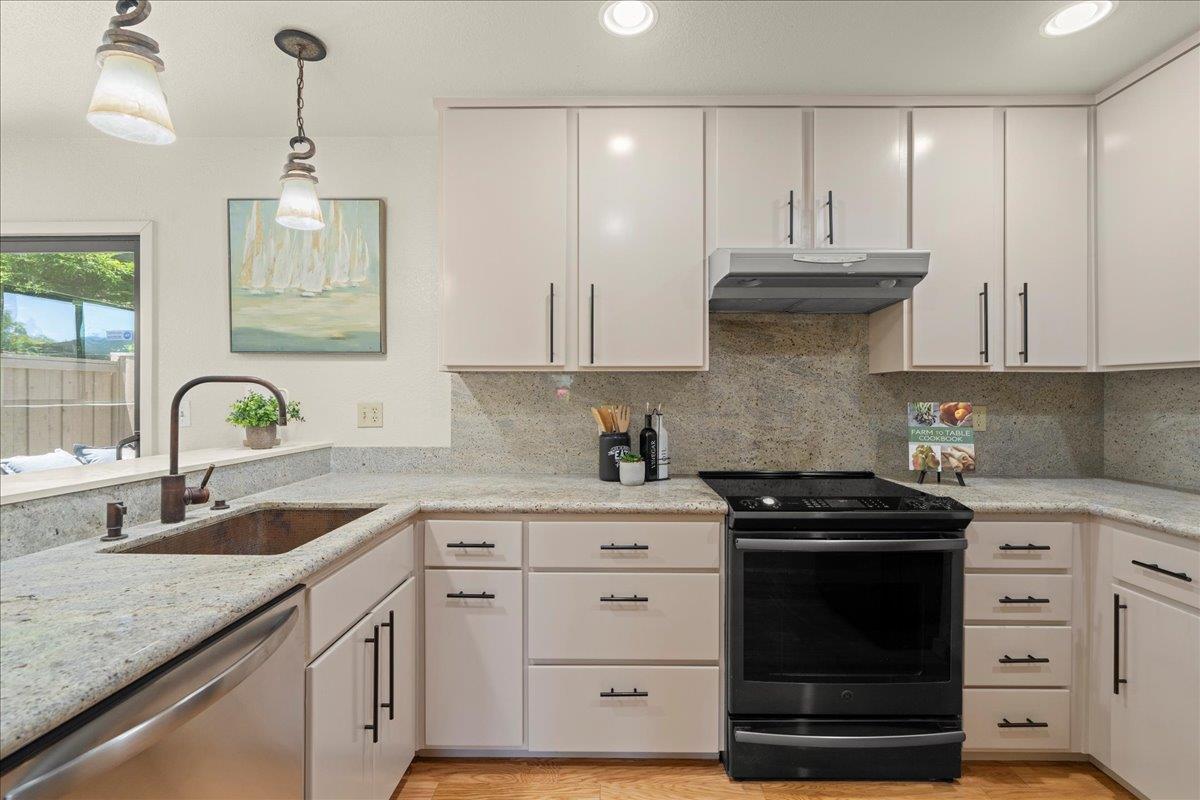 6109 Sheraton Place Aptos, CA 95003 - Photo 6 of 31 a kitchen with granite countertop a sink a stove and cabinets