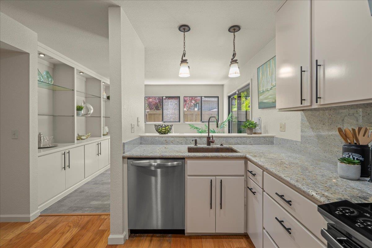 6109 Sheraton Place Aptos, CA 95003 - Photo 7 of 31 a kitchen with granite countertop a sink cabinets and stainless steel appliances