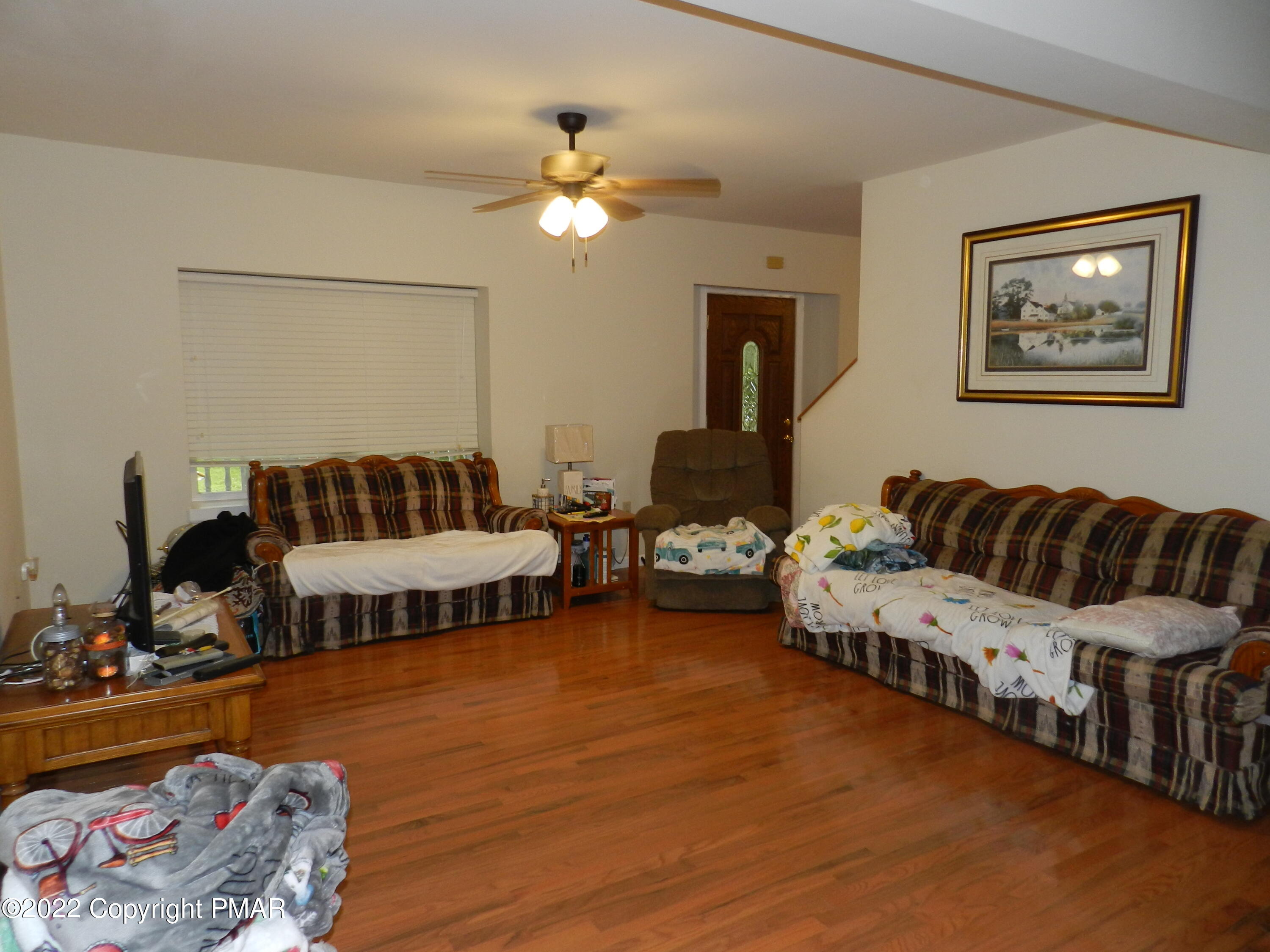 1269 Burger Hollow Road Effort, PA 18330 - Photo 21 of 49 a living room with furniture and a chandelier