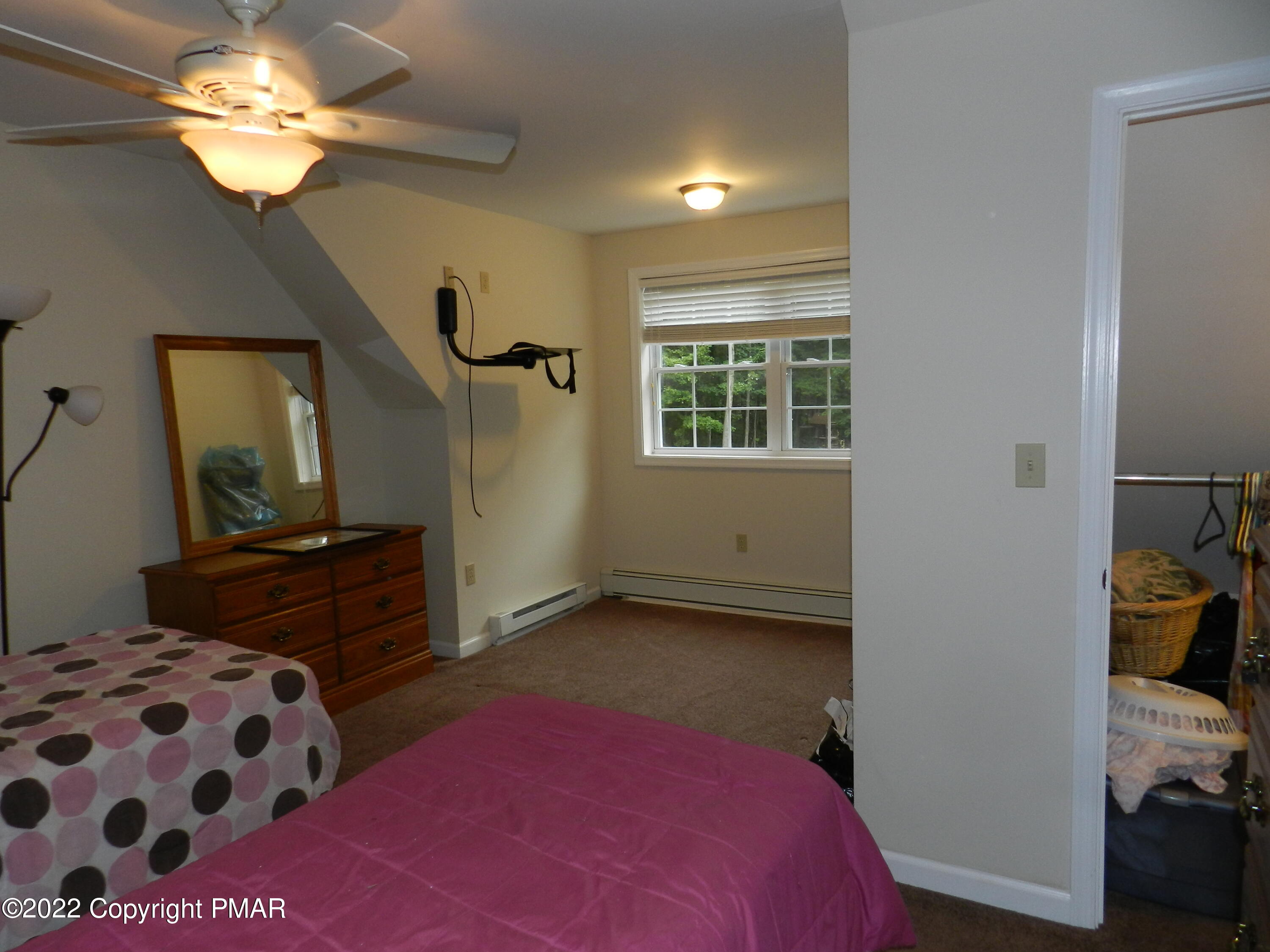 1269 Burger Hollow Road Effort, PA 18330 - Photo 34 of 49 a bedroom with a bed chandelier and a window