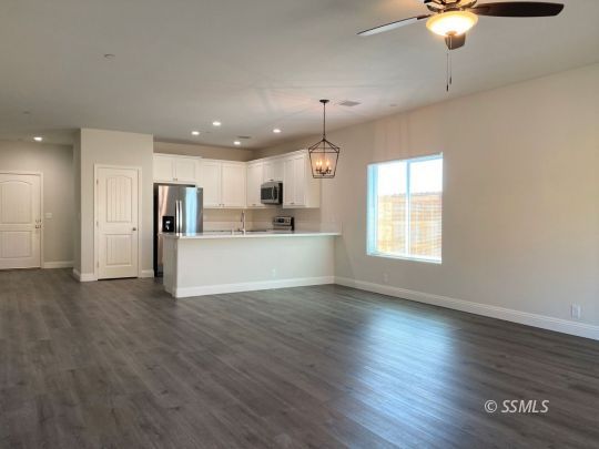 1517 Mayo Street Ridgecrest, CA 93555 - Photo 13 of 32 a view of kitchen with refrigerator stove and wooden floor