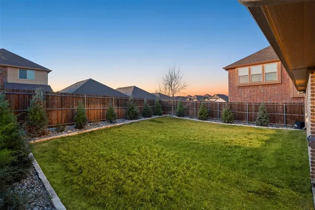 a view of a house with a yard and sitting area
