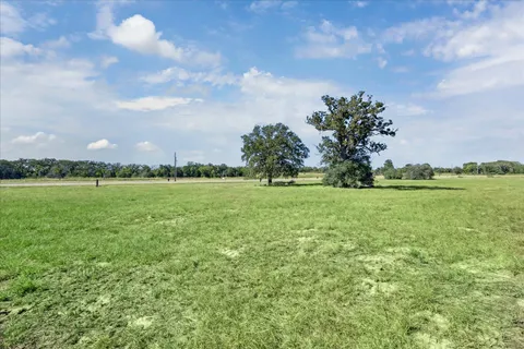 a view of a green field with clear sky