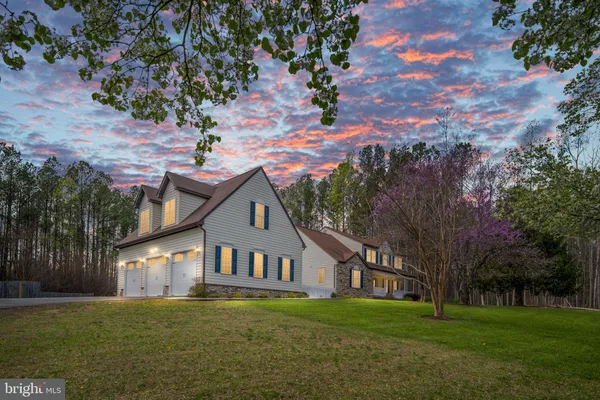 a view of a hallway with wooden floor and entryway