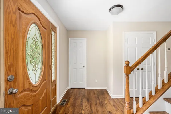 a view of a dining room with furniture a chandelier and wooden floor