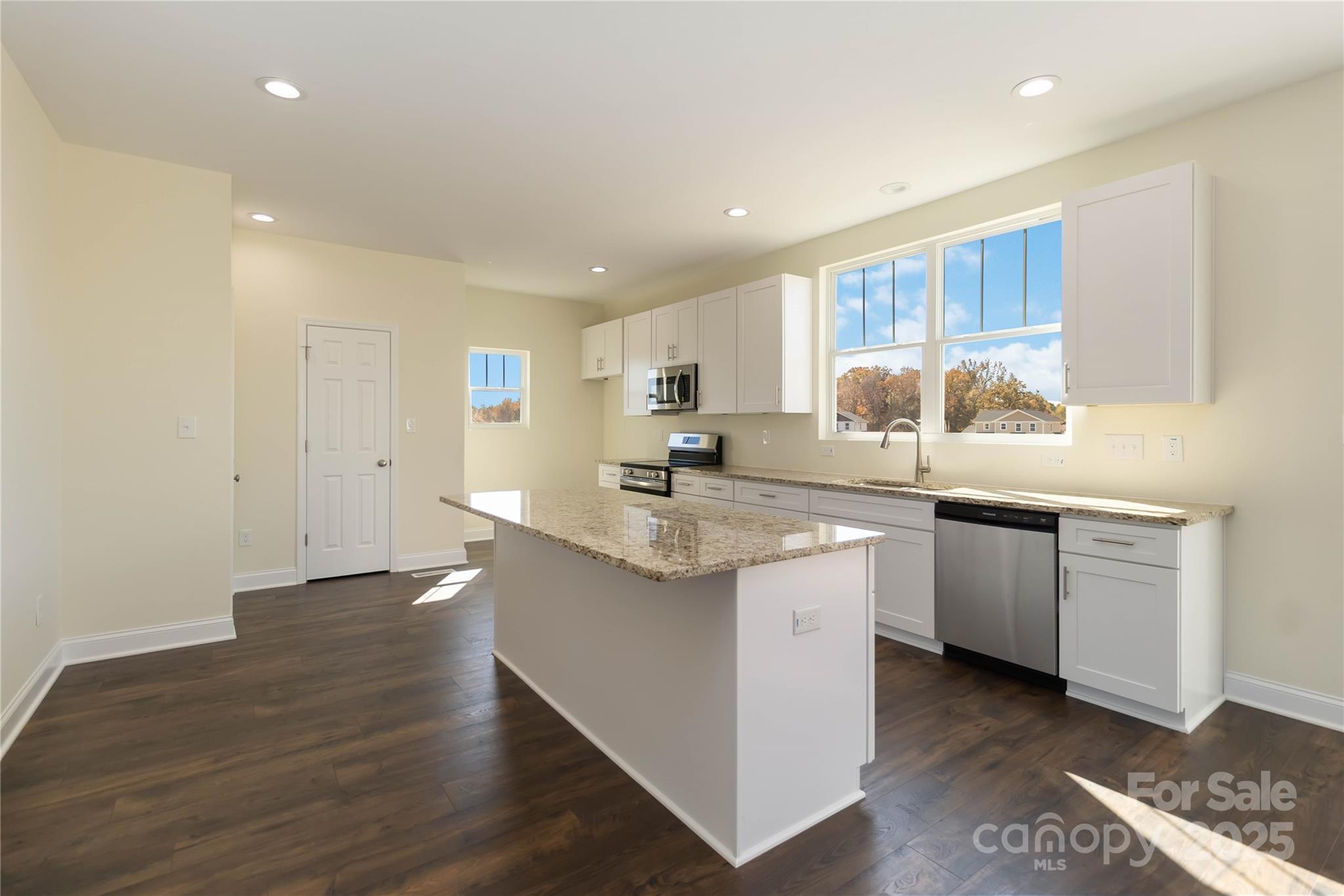 1018 Heath Helms Road Monroe, NC 28110 - Photo 11 of 38 a kitchen with granite countertop a sink and cabinets