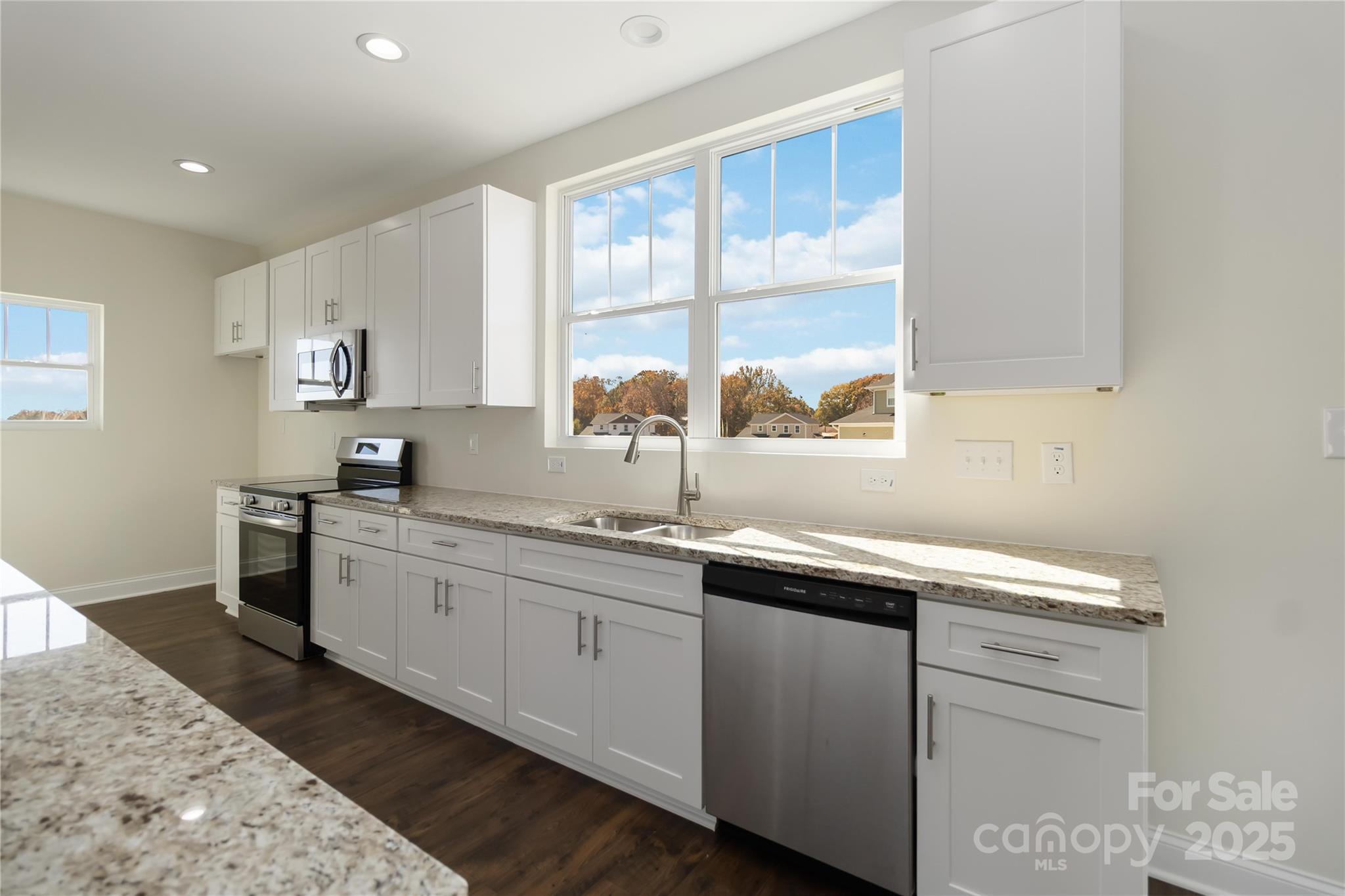 1018 Heath Helms Road Monroe, NC 28110 - Photo 12 of 38 a kitchen with sink cabinets and window