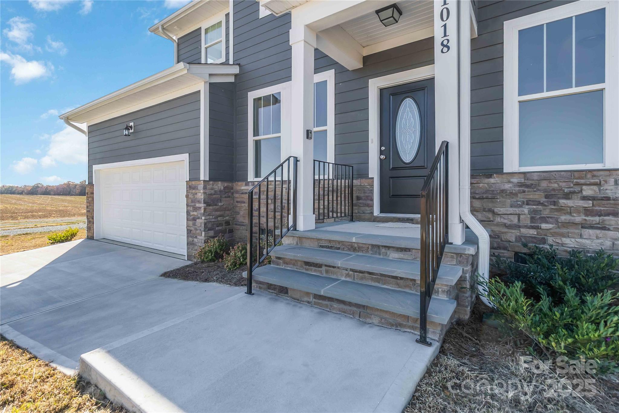 1018 Heath Helms Road Monroe, NC 28110 - Photo 3 of 38 a front view of a house with a yard