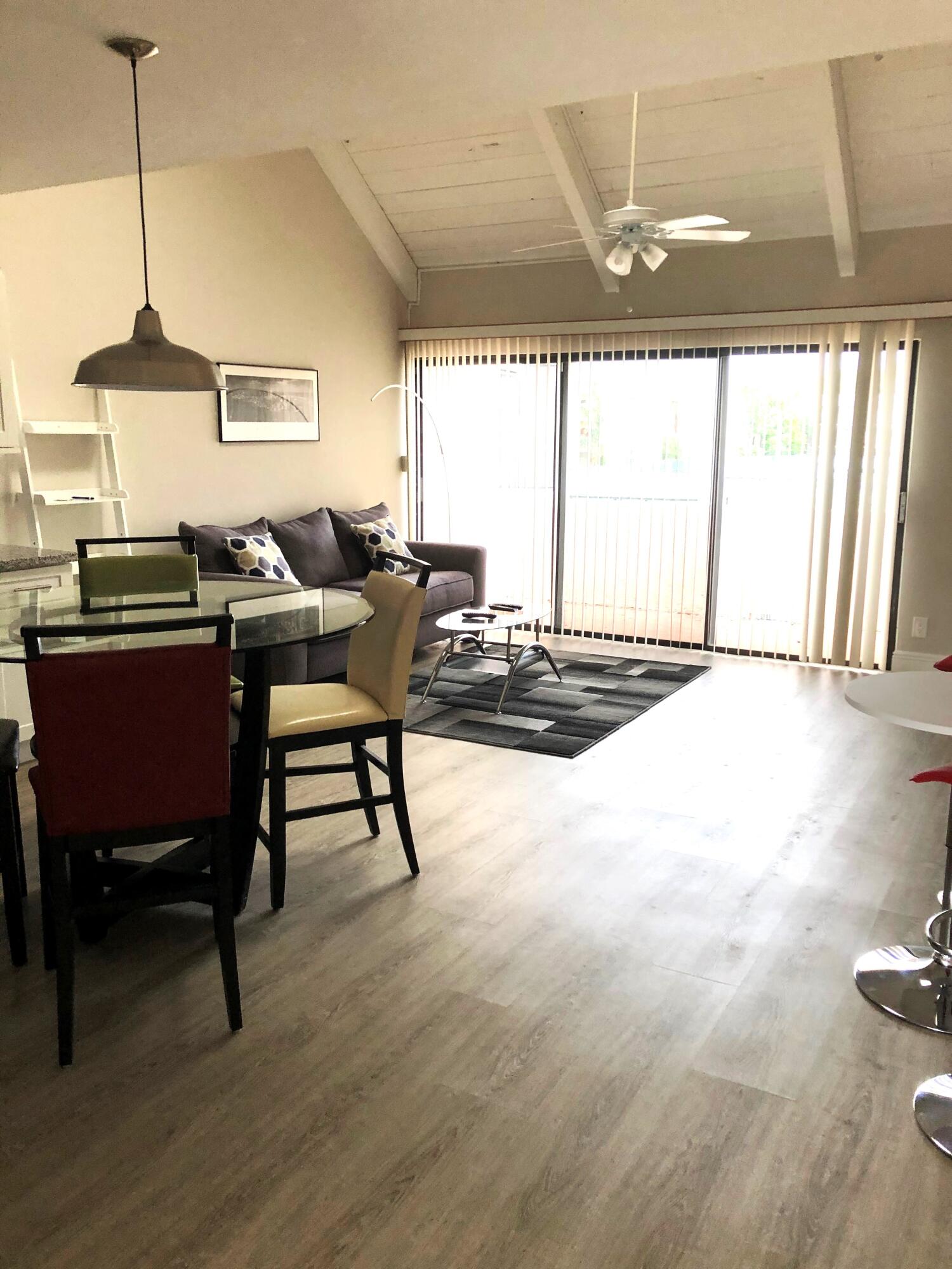 9 Deer Creek Road, Unit A206 Deerfield Beach, FL 33442 - Photo 3 of 6 a dining room with furniture and window