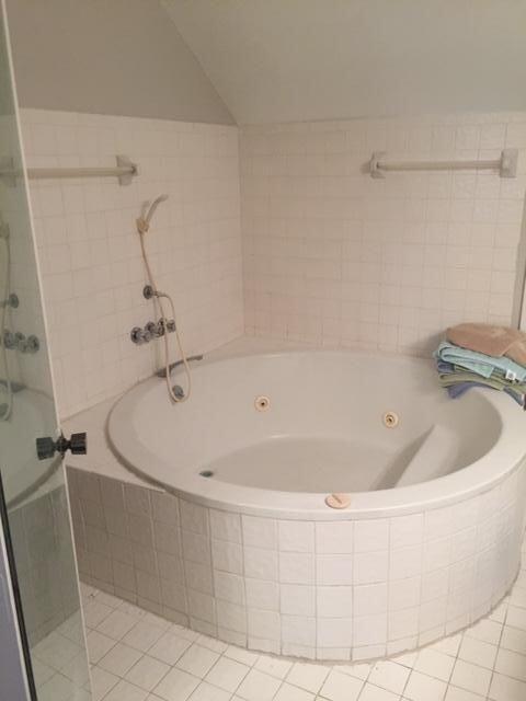 9 Deer Creek Road, Unit A206 Deerfield Beach, FL 33442 - Photo 5 of 6 a white bath tub sitting in a shower