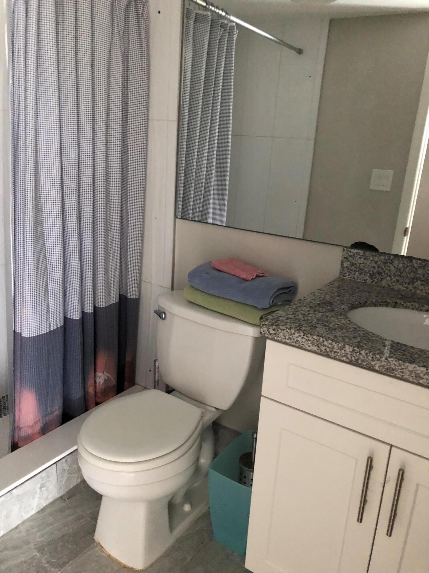 9 Deer Creek Road, Unit A206 Deerfield Beach, FL 33442 - Photo 6 of 6 a bathroom with a toilet and a shower