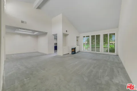 a view of a big room with closet and windows