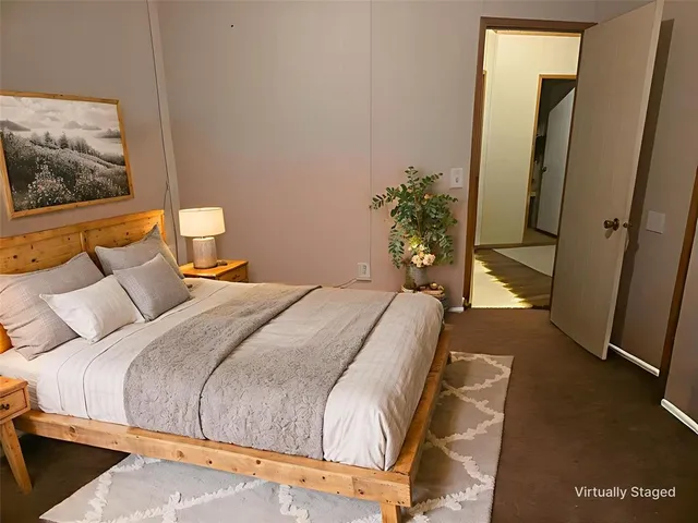 a bedroom with a bed and a painting on the wall