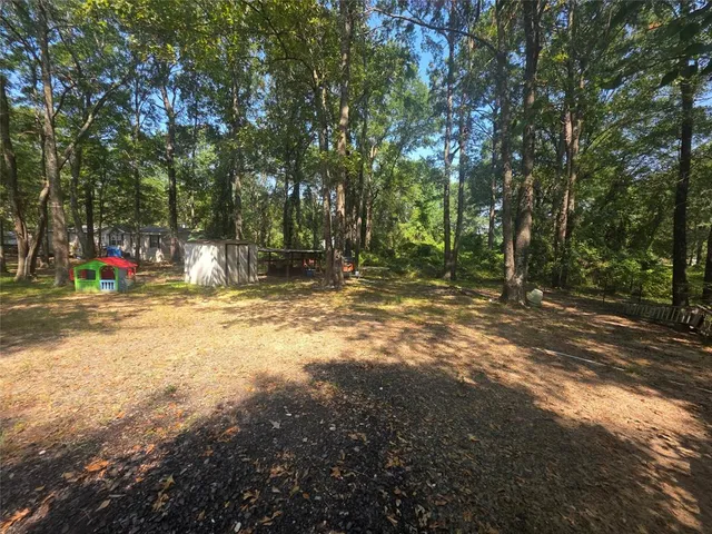 a view of outdoor space with trees all around