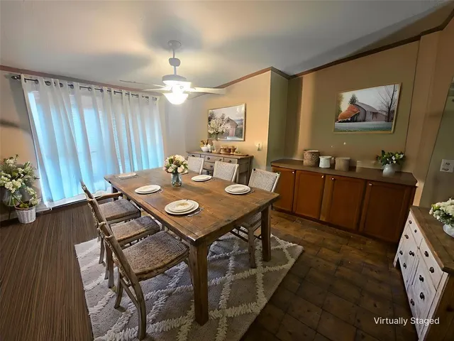 a view of a dining room with furniture and wooden floor