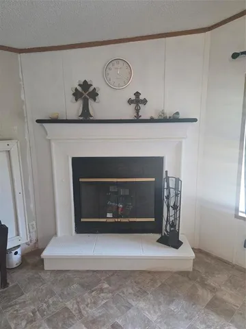 a living room with a fireplace and a rug