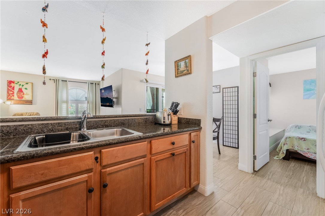 3145 East Flamingo Road, Unit 1092 Las Vegas, NV 89121 - Photo 11 of 33 A well-appointed kitchen with granite counters and rich wood cabinetry flows into an inviting living area.