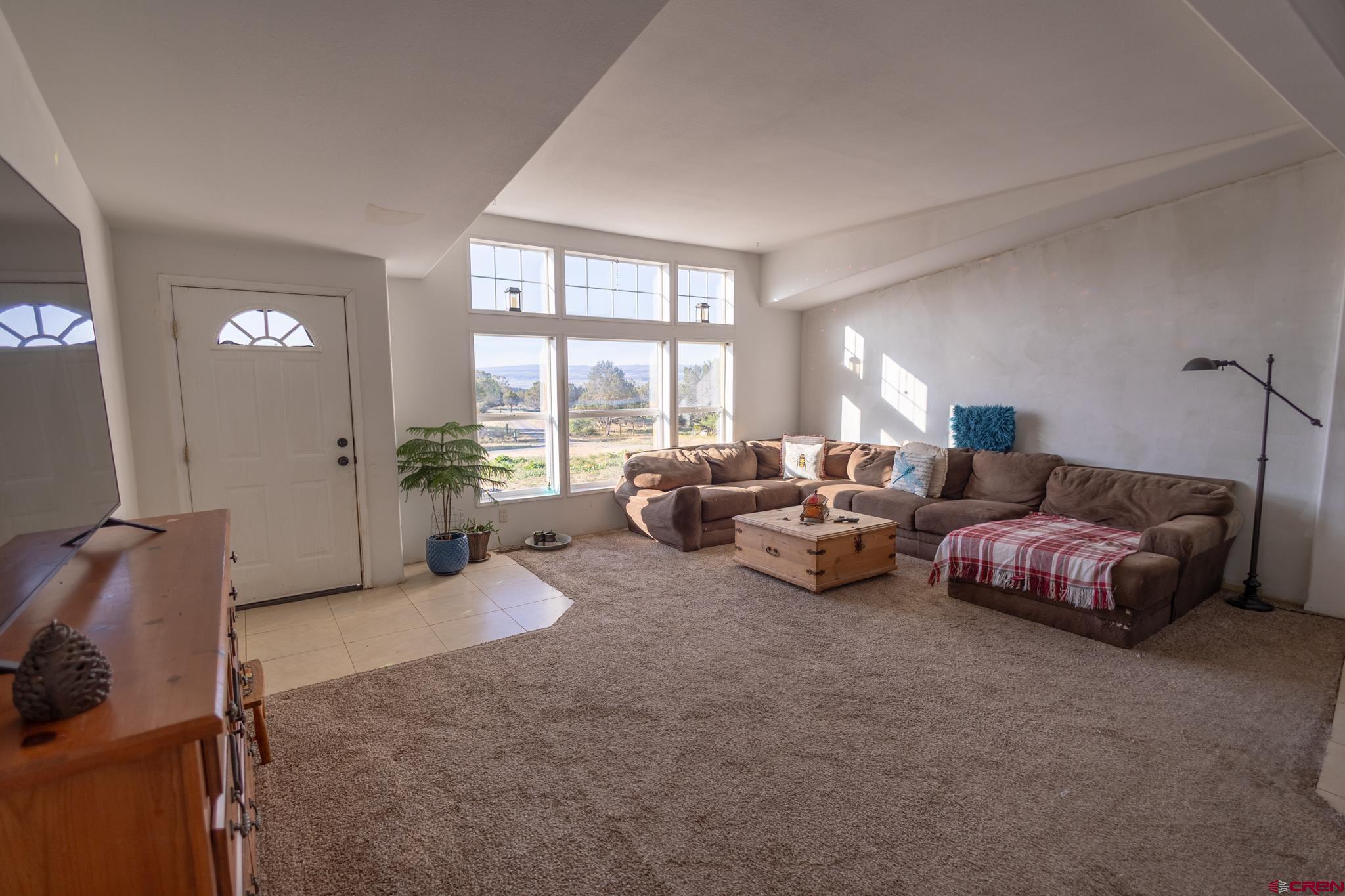 13569 3100th Road Hotchkiss, CO 81419 - Photo 12 of 31 a living room with furniture and large windows
