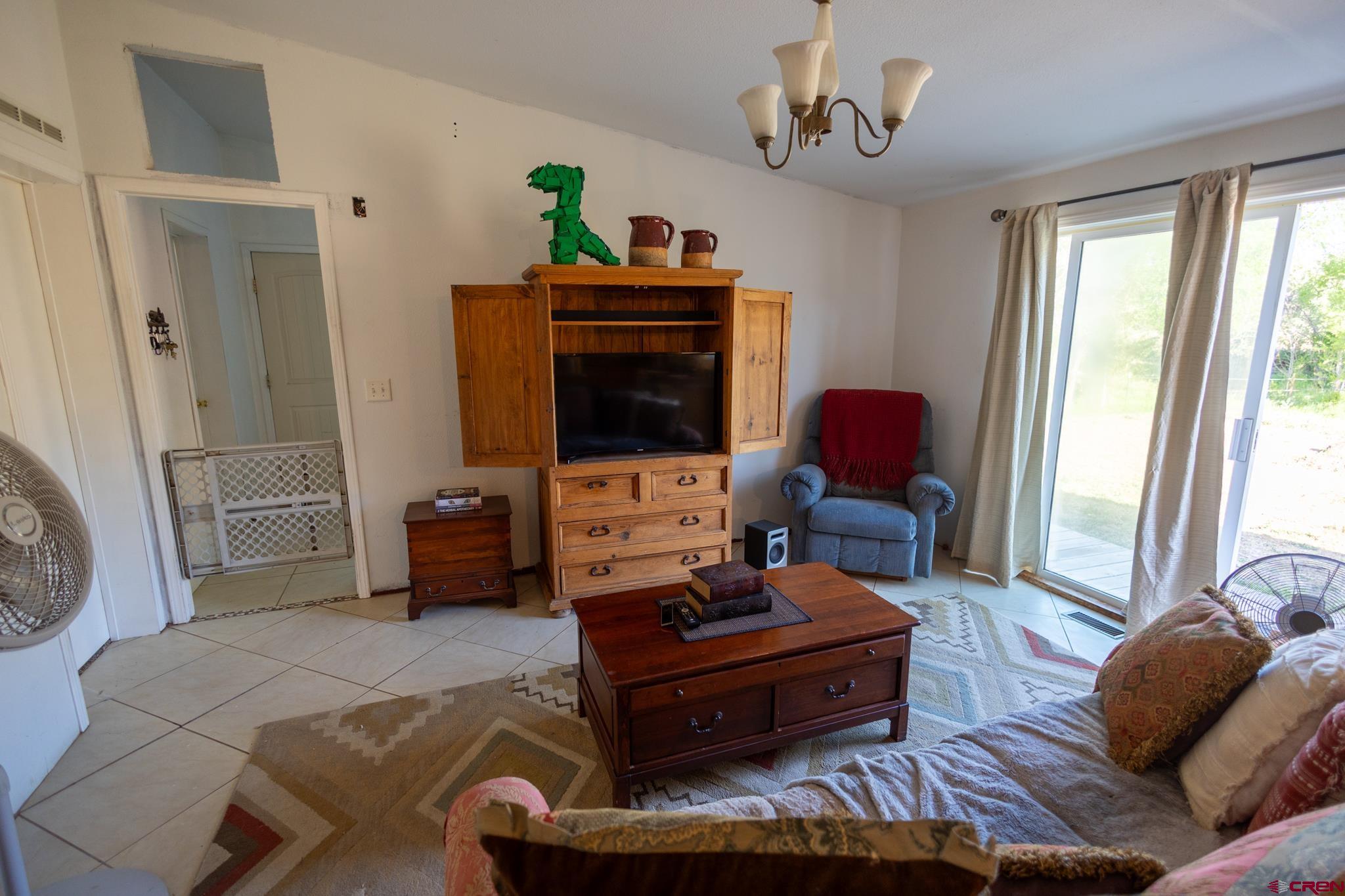 13569 3100th Road Hotchkiss, CO 81419 - Photo 16 of 31 a living room with furniture and a flat screen tv
