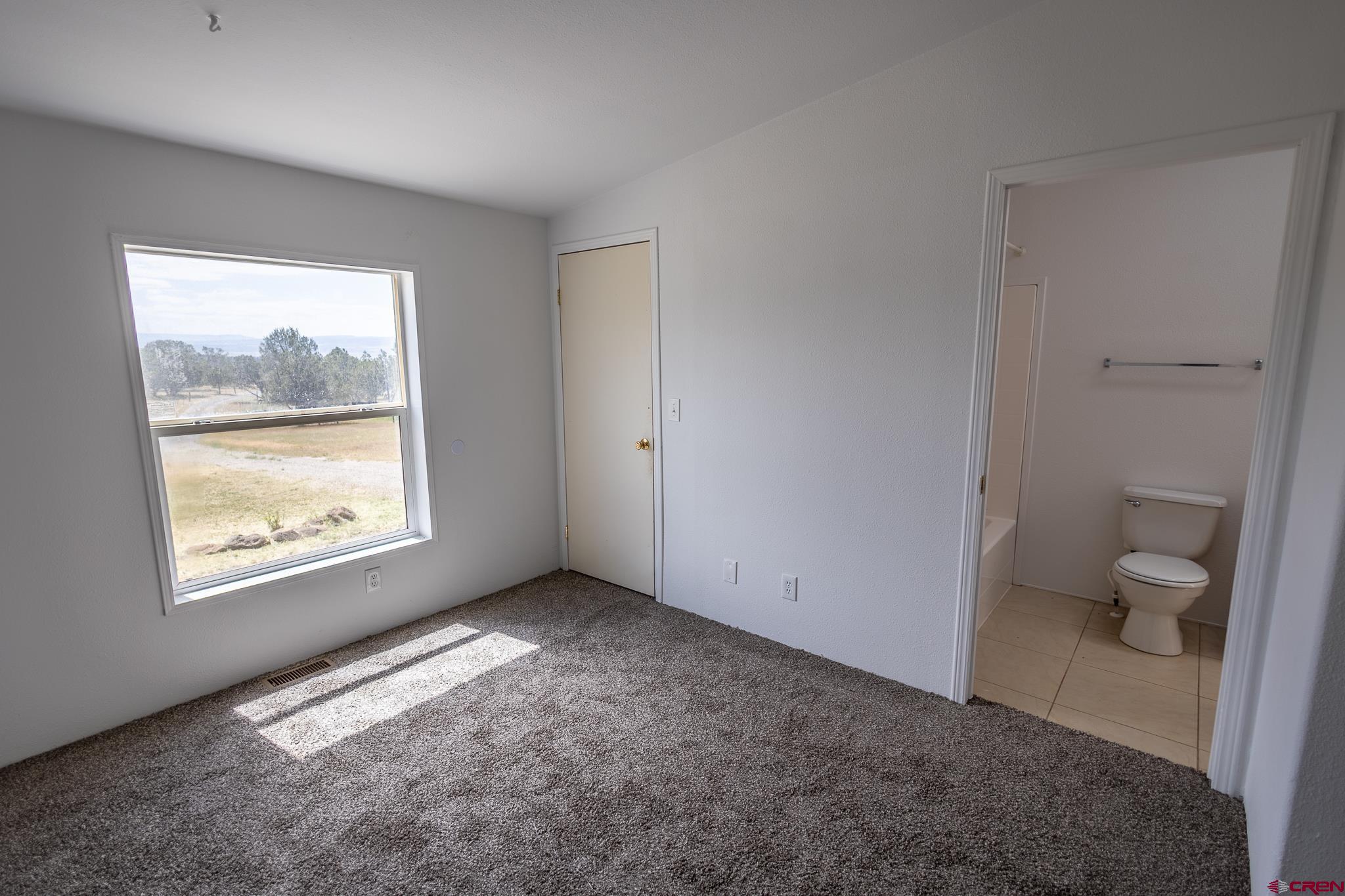 13569 3100th Road Hotchkiss, CO 81419 - Photo 16 of 29 a view of an empty room with a window and a bathroom