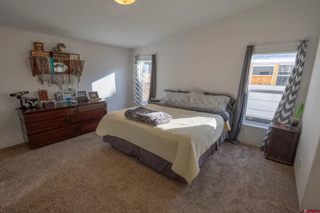 a bedroom with a bed and window