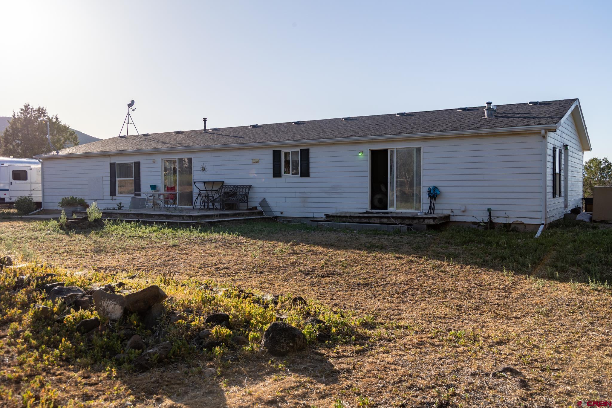 13569 3100th Road Hotchkiss, CO 81419 - Photo 2 of 31 a view of a house with a yard