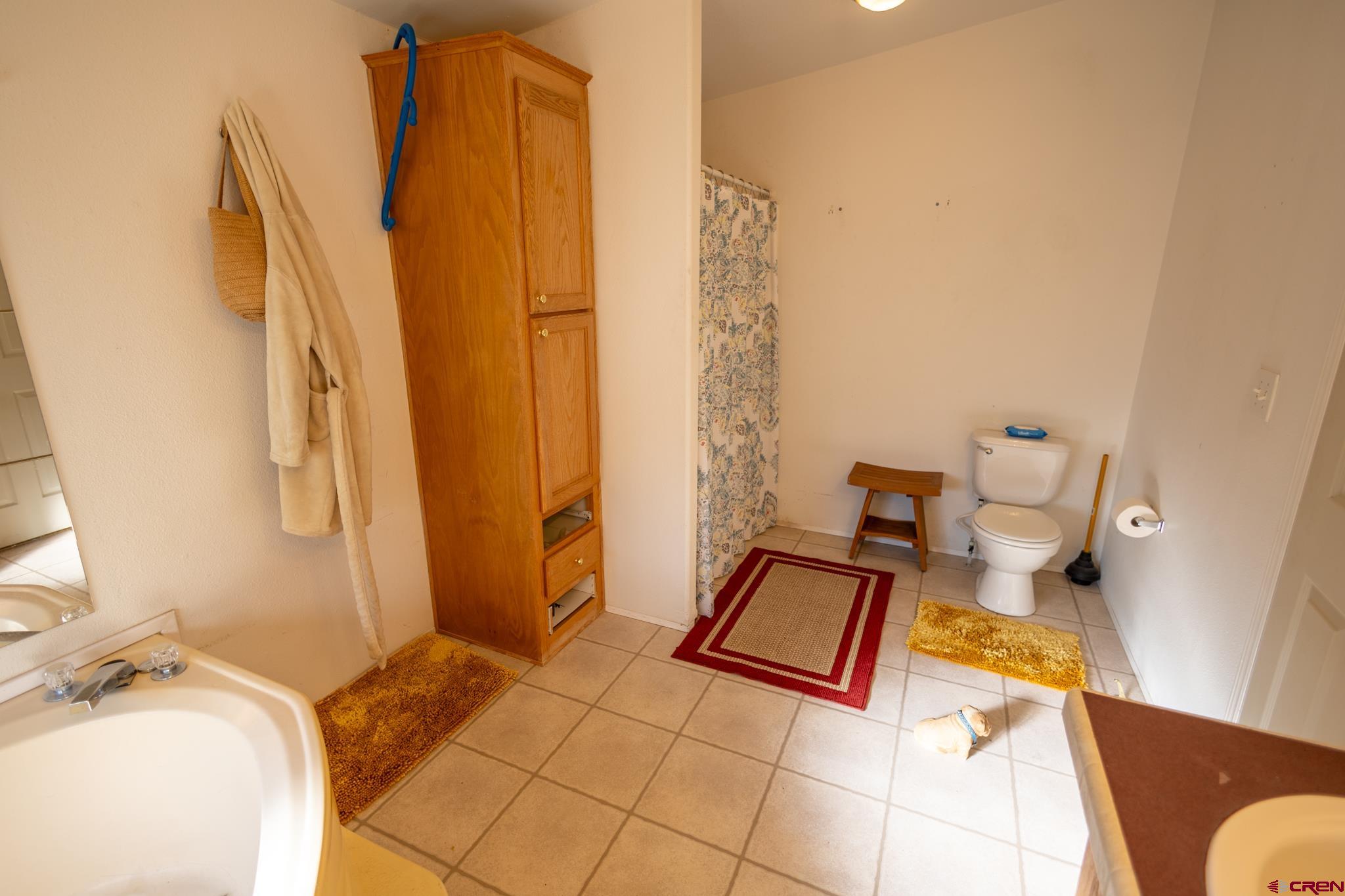 13569 3100th Road Hotchkiss, CO 81419 - Photo 23 of 31 a bedroom with a bed and wooden floor