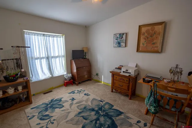 a bedroom with furniture and a window