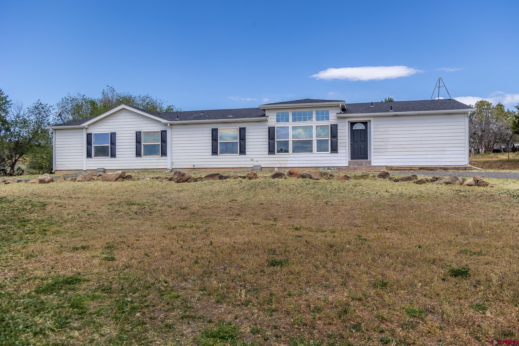 13569 3100th Road Hotchkiss, CO 81419 - Photo 3 of 29 a house with trees in the background
