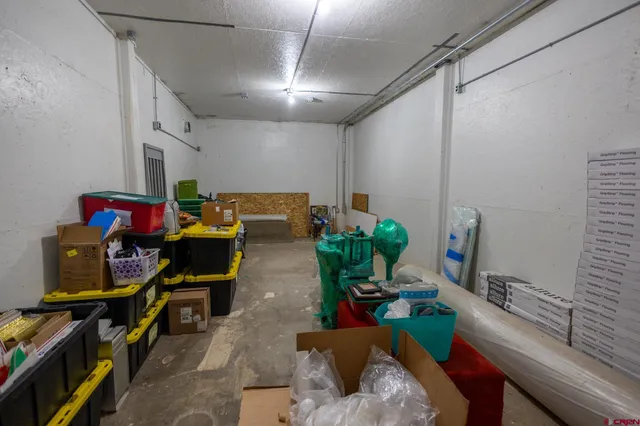 a living room with furniture and a gym machine