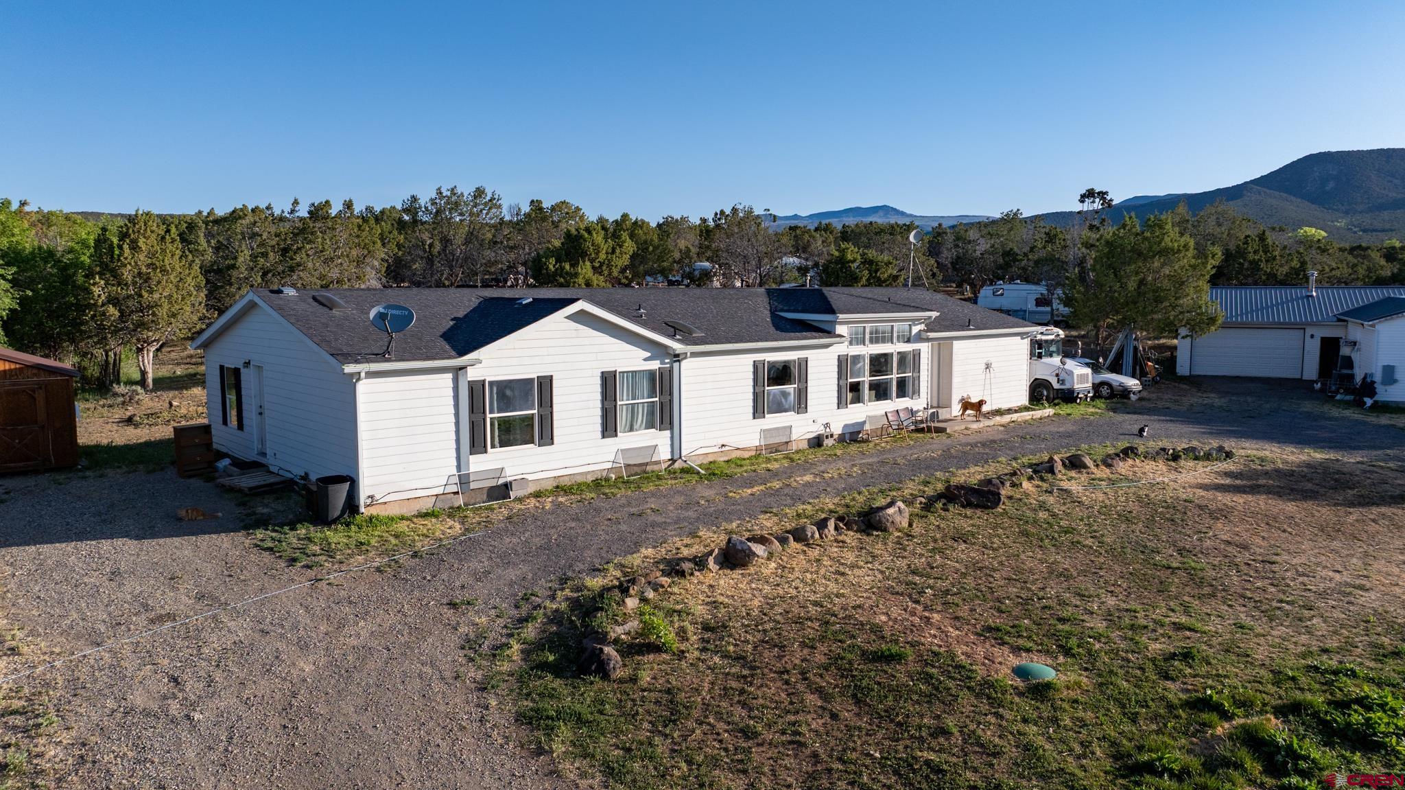 13569 3100th Road Hotchkiss, CO 81419 - Photo 7 of 31 a view of a house with a yard