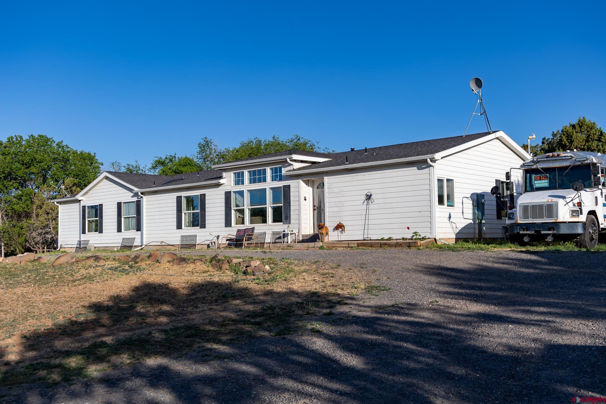 13569 3100th Road Hotchkiss, CO 81419 - Photo 8 of 31 a front view of a house with a garden