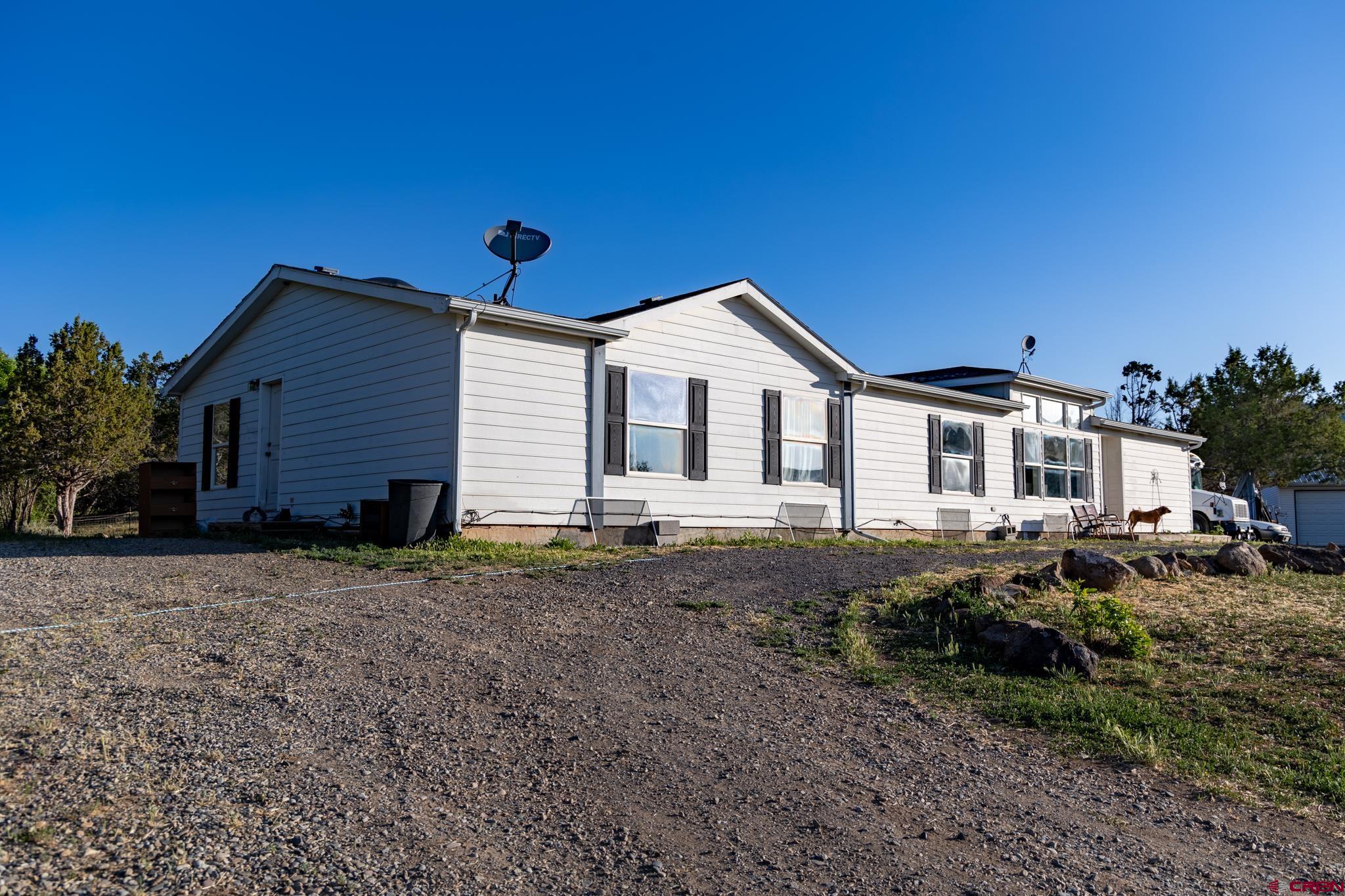 13569 3100th Road Hotchkiss, CO 81419 - Photo 9 of 31 a front view of a house with a yard