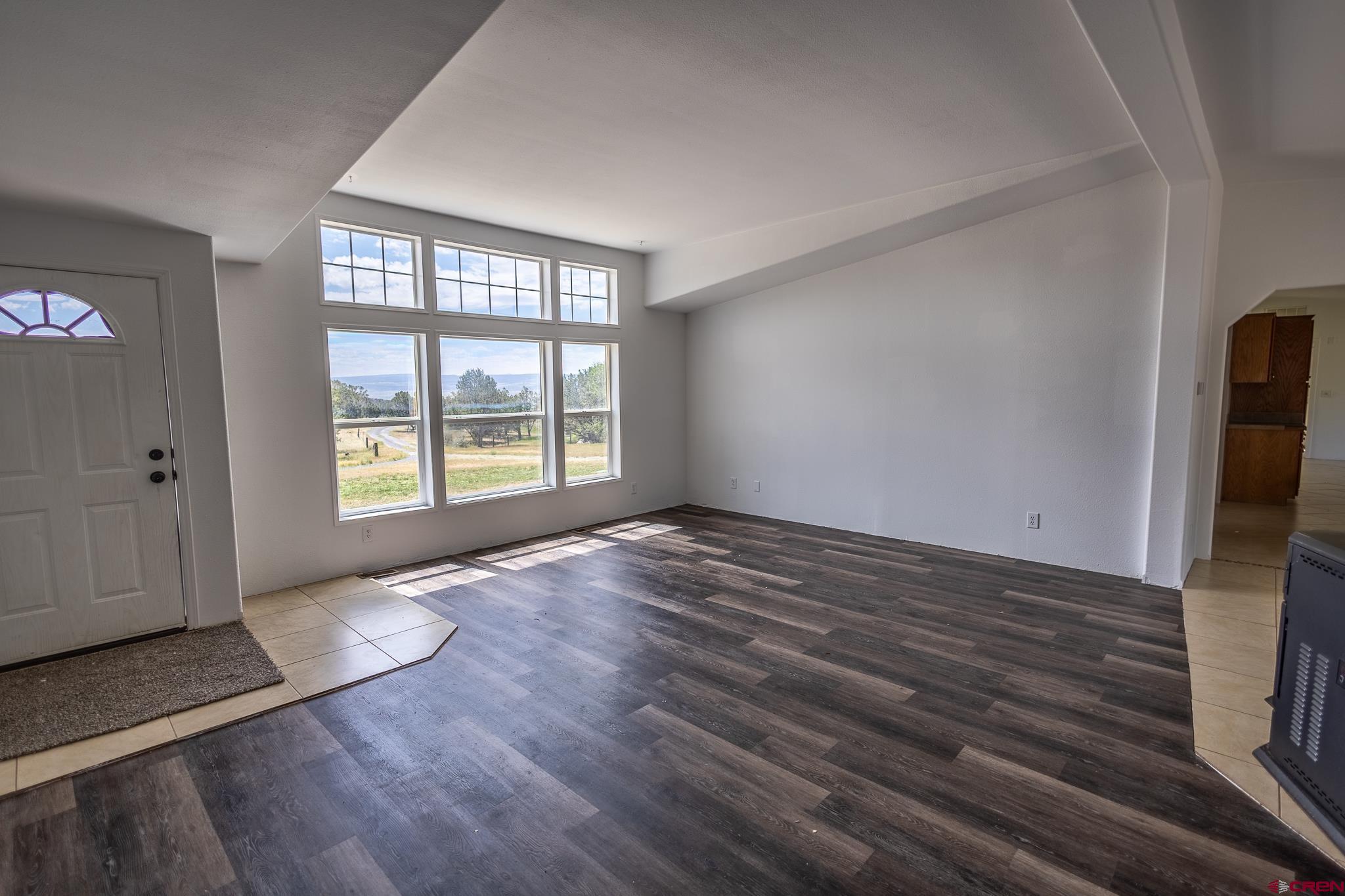 13569 3100th Road Hotchkiss, CO 81419 - Photo 9 of 29 wooden floor in an empty room with a window