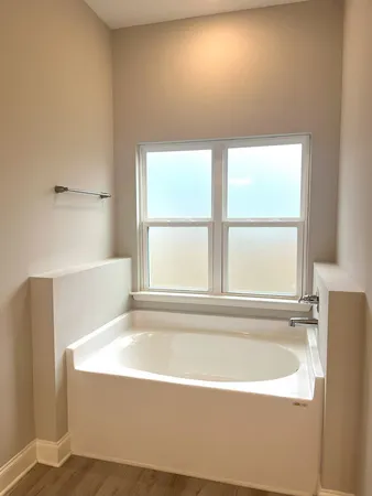 a white bath tub sitting next to a window