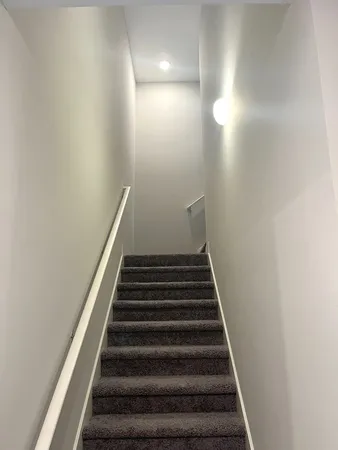 an empty room with windows and closet area