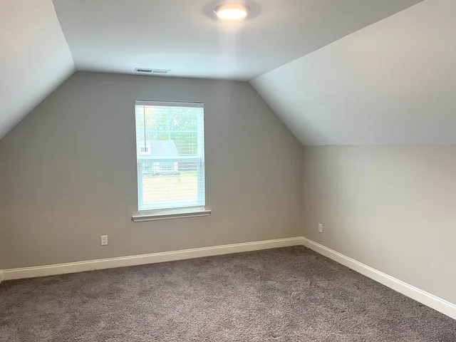 a bathroom with a granite countertop toilet a sink and a mirror