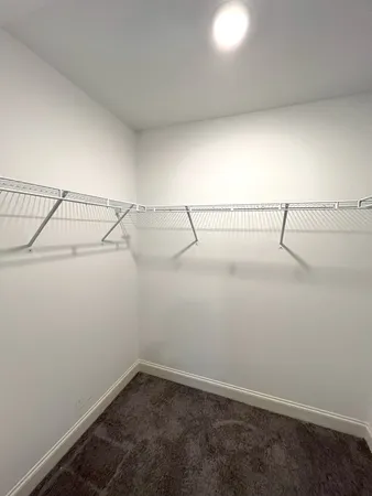 a bathroom with a granite countertop sink toilet a mirror and shower