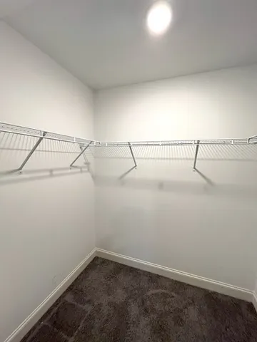 a bathroom with a granite countertop sink toilet a mirror and shower