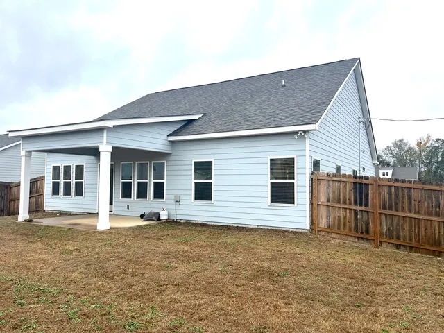 a house view with swimming pool and porch