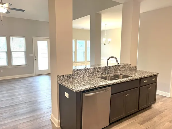 a bathroom with a granite countertop sink and a large mirror