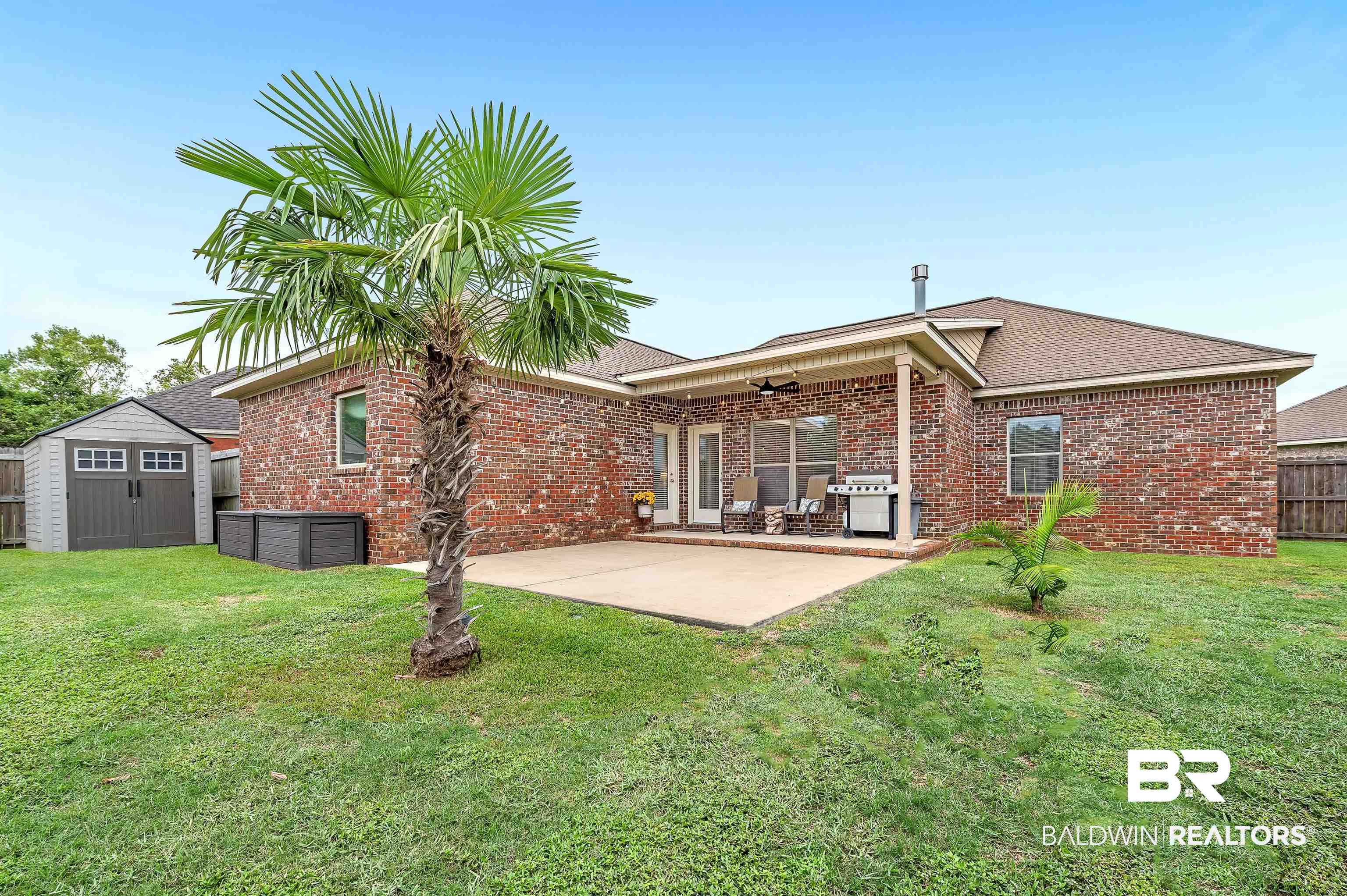 9376 Sable Court Daphne, AL 36526 - Photo 40 of 46 Back of house featuring a yard, a storage shed, a patio, and ceiling fan