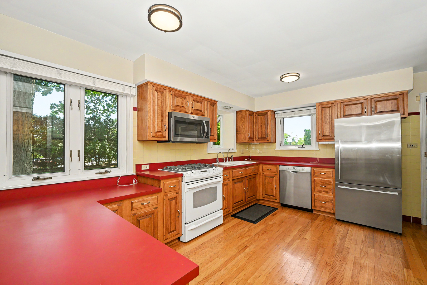325 South Lambert Road Glen Ellyn, IL 60137 - Photo 14 of 32 a kitchen with stainless steel appliances granite countertop a refrigerator a stove top oven and a sink with wooden floor