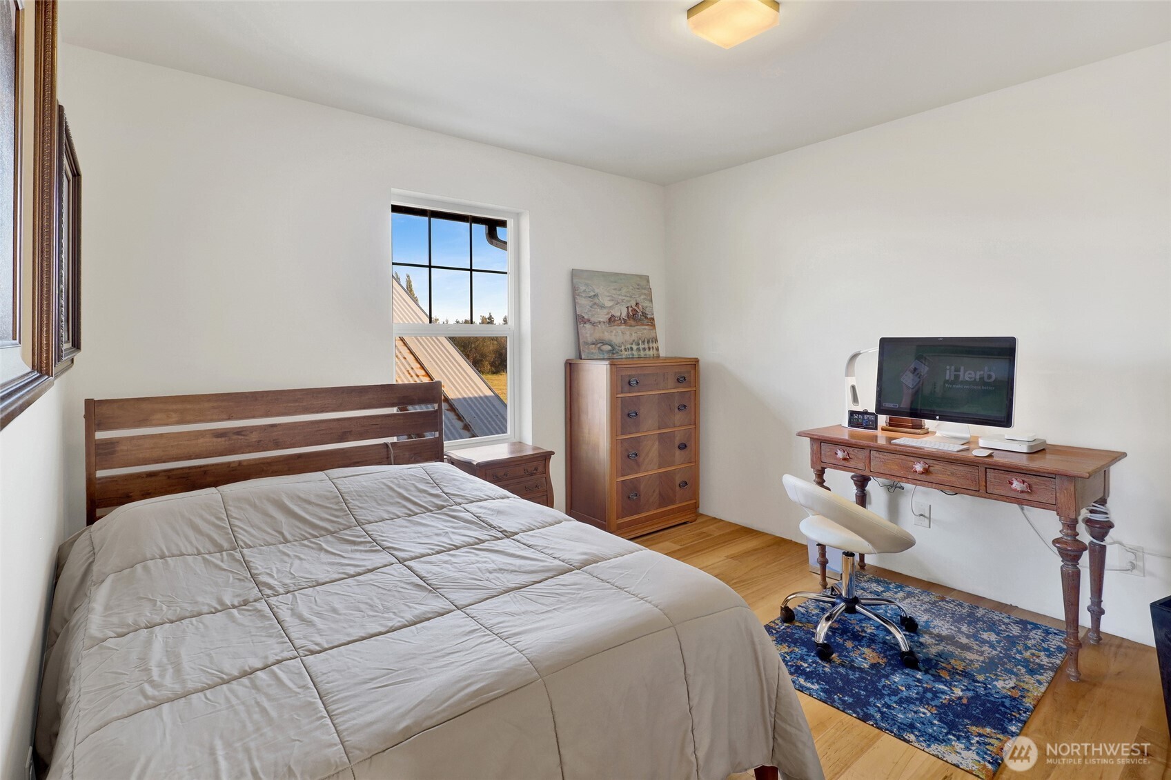 5544 Smith Road Bow, WA 98232 - Photo 25 of 40 a bedroom with a bed and a tv on the dresser