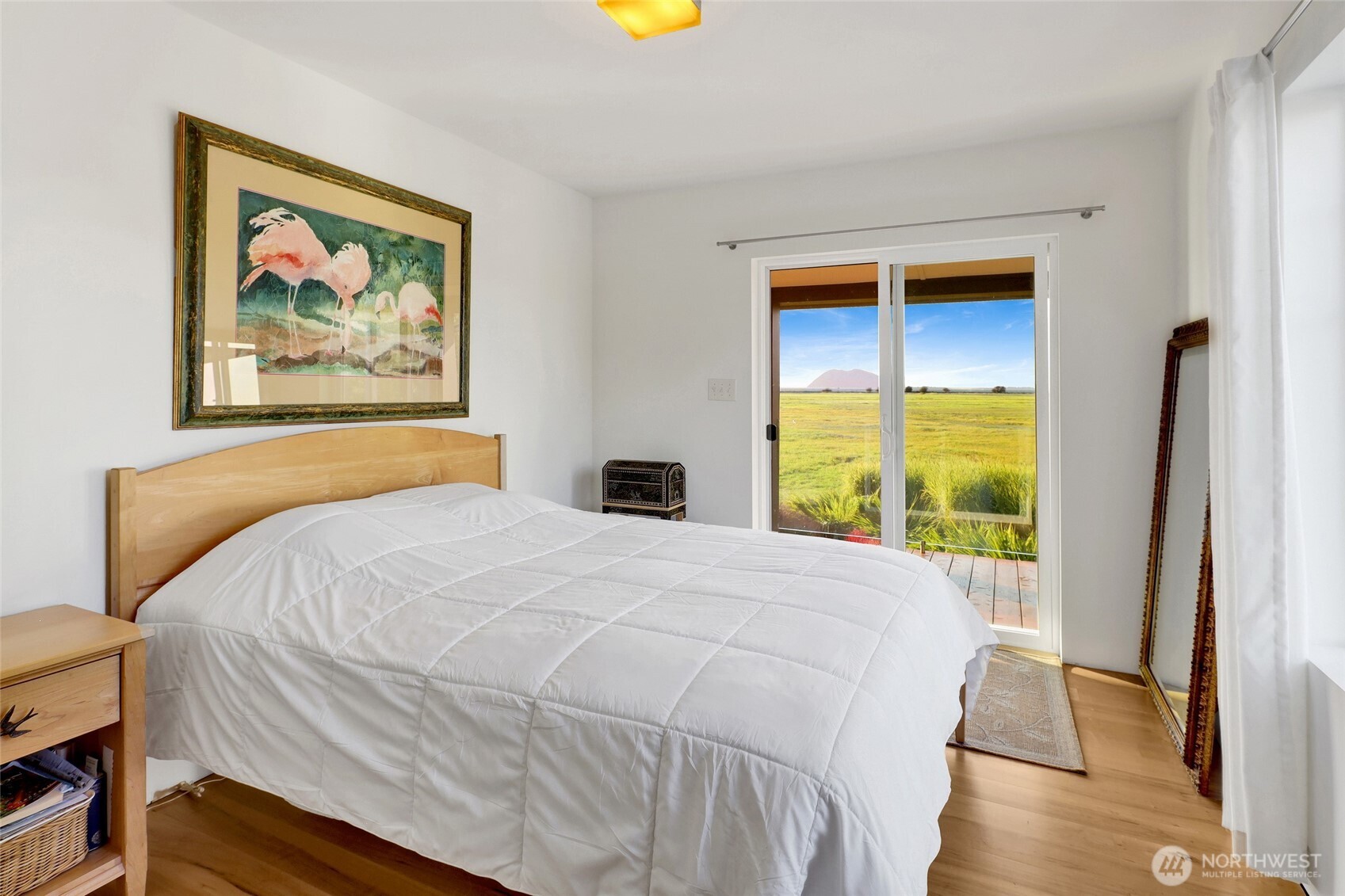 5544 Smith Road Bow, WA 98232 - Photo 28 of 40 a bedroom with a bed and a painting on the wall