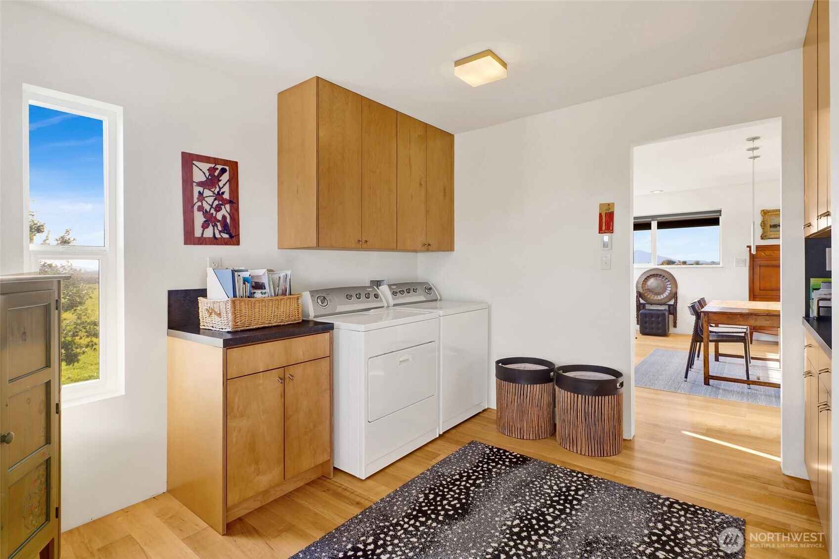 5544 Smith Road Bow, WA 98232 - Photo 29 of 40 a living room with a couch and a table with wooden floor