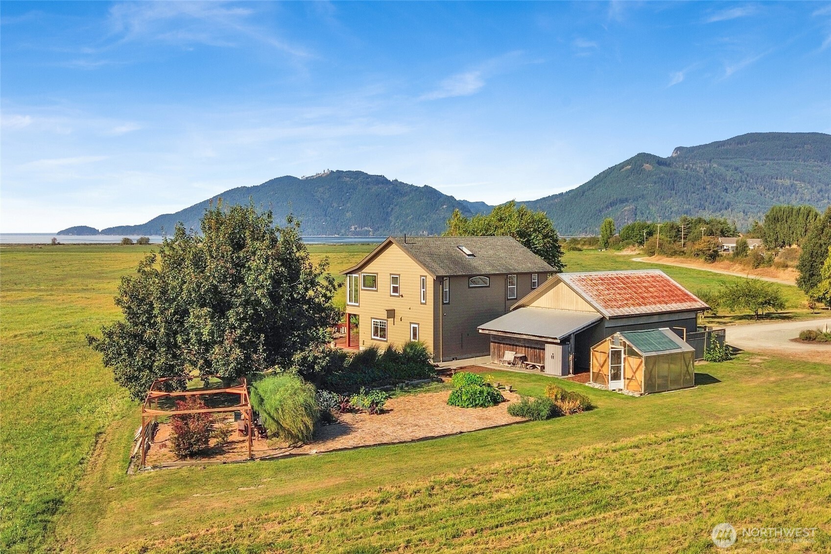 5544 Smith Road Bow, WA 98232 - Photo 36 of 40 an aerial view of a house with a garden and lake view