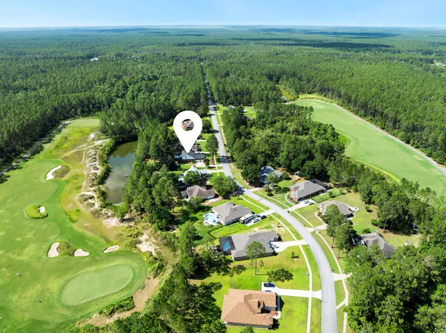 an aerial view of a house with yard swimming pool and outdoor seating