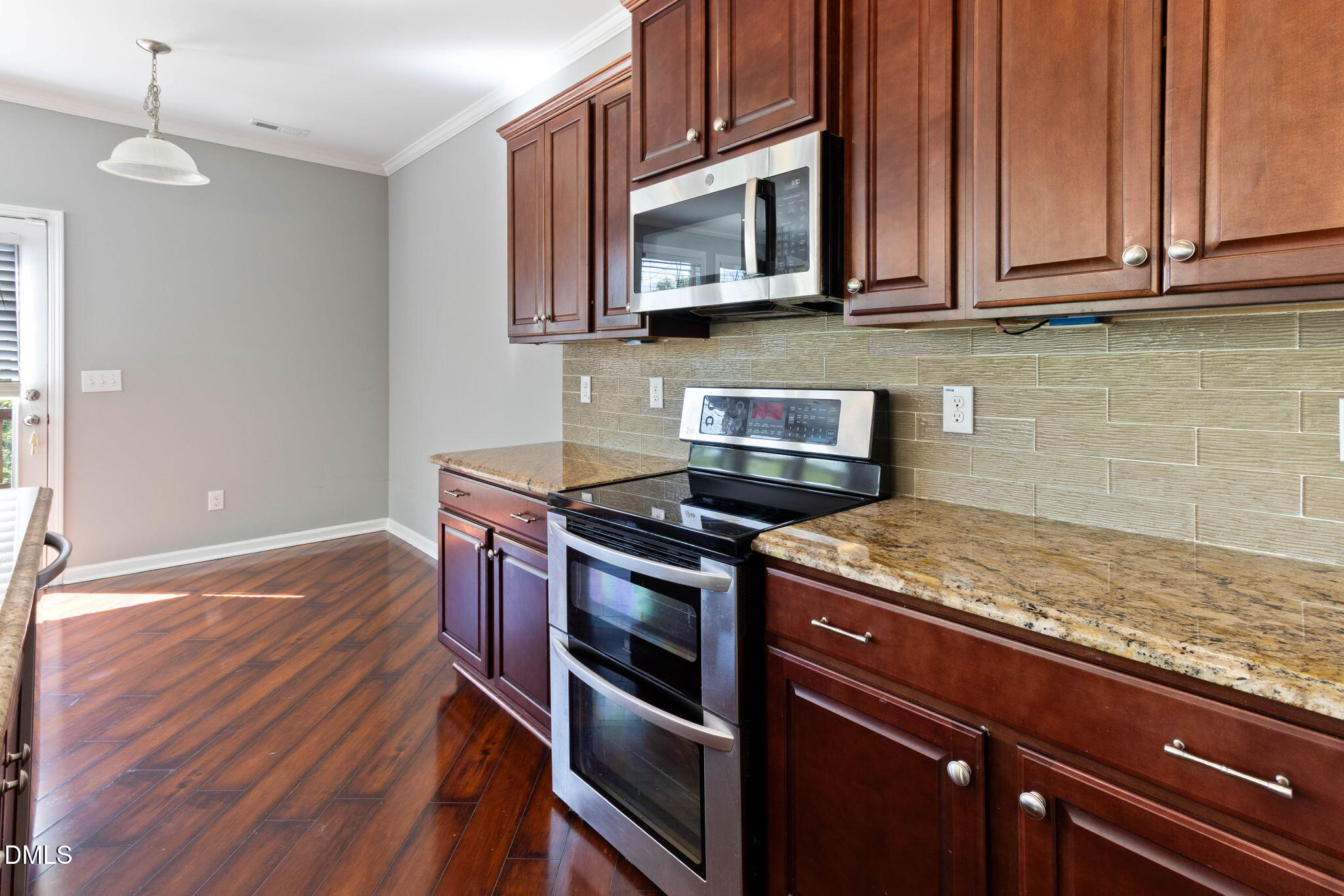 14303 Foxcroft Road Raleigh, NC 27614 - Photo 20 of 70 a kitchen with stainless steel appliances granite countertop a stove microwave and cabinets