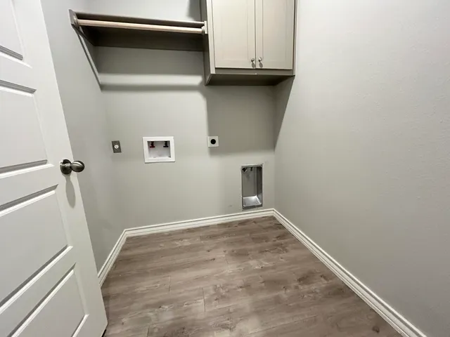 a view of a utility room with cabinets